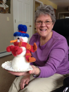 Chris' needlefelted snowman wears a scarf made from the yarns and wears mittens made from the unspun fiber. His heart is, too.